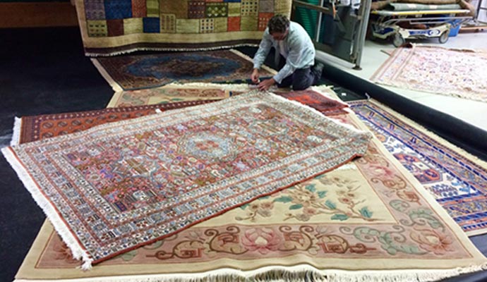 inspecting and cleaning rug